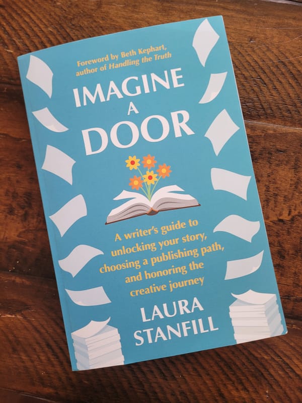 The cover of Imagine a Door by Laura Stanfill is blue with an illustration of an open book sprouting colorful flowers.